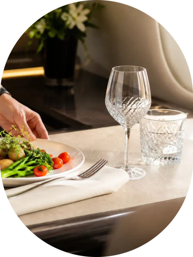 Gourmet private jet meal with linen and glassware